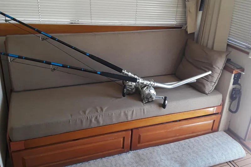 Slide: The Image of Fishing rods on a cushioned bench inside a 1987 Blackfin 36 Convertible boat. - 42