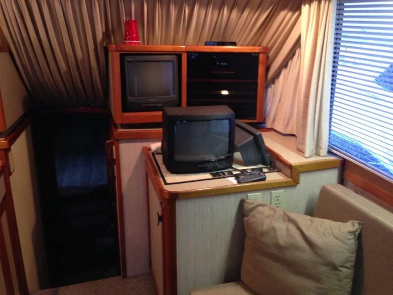 Slide: The Image of 1987 Blackfin 36 Convertible interior with vintage TVs and cozy seating. - 47