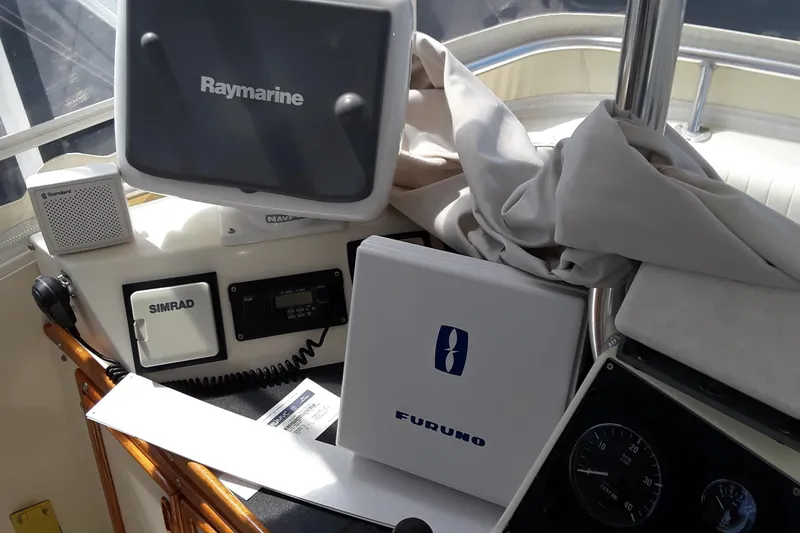 Slide: The Image of Control panel of a 1987 Blackfin 36 Convertible boat with Raymarine, Simrad, and Furuno equipment. - 49