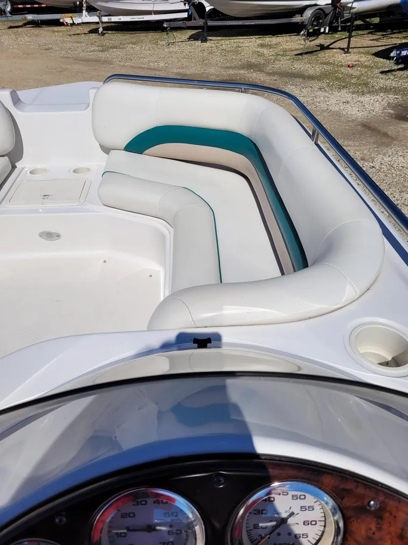 Slide: The Image of 2000 Hurricane Fun Deck 201IO boat interior with white and teal seating. - 10