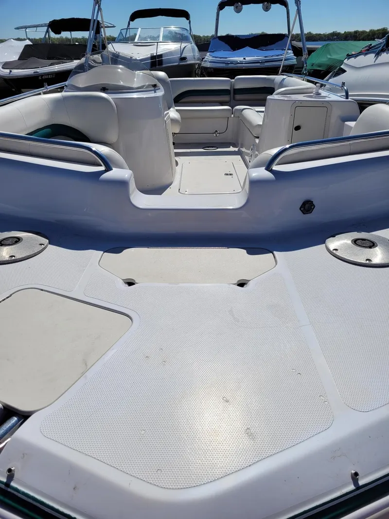 Slide: The Image of 2000 Hurricane Fun Deck 201IO boat interior with seating and storage compartments. - 12