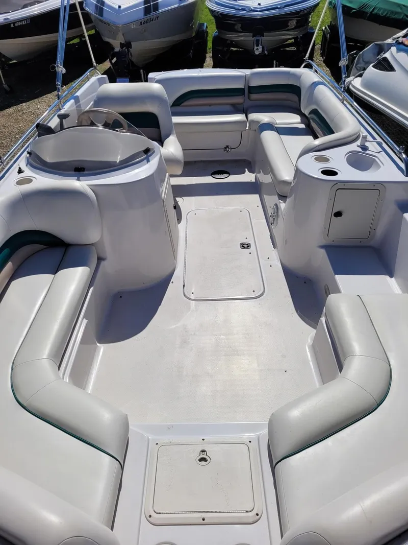 Slide: The Image of 2000 Hurricane Fun Deck 201IO boat interior with spacious seating and storage compartments. - 13