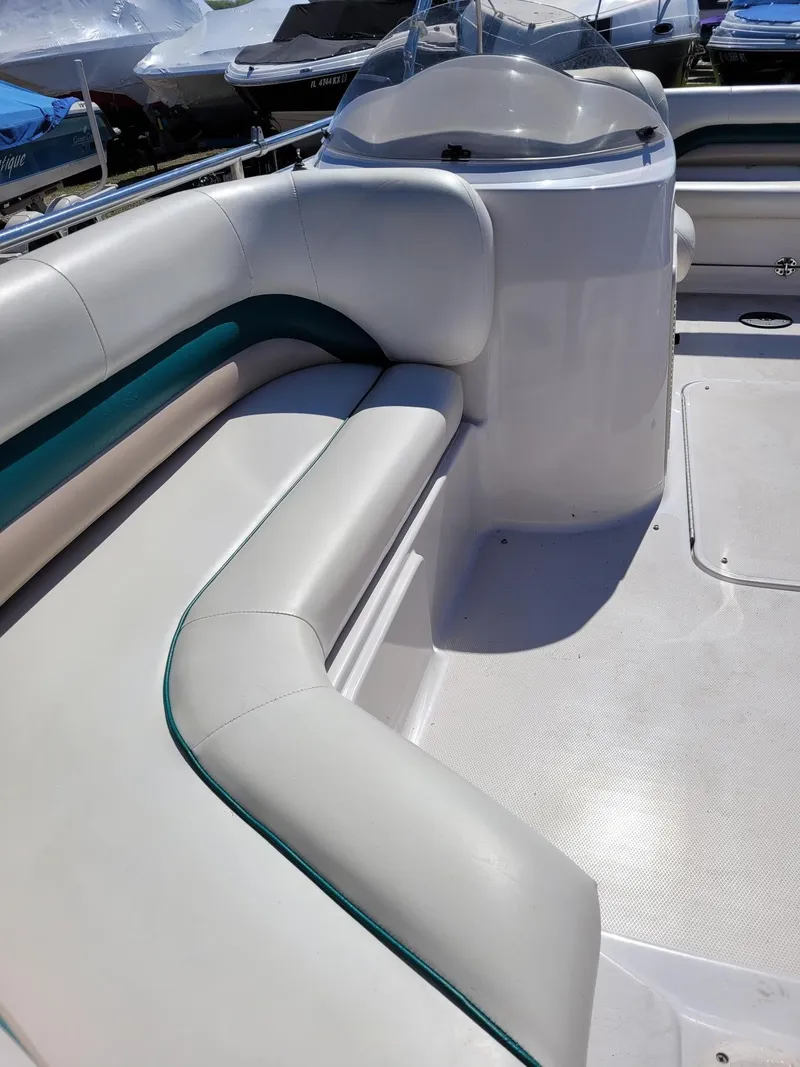 Slide: The Image of 2000 Hurricane Fun Deck 201IO boat interior with white and teal seating. - 14