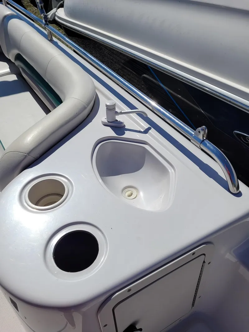 Slide: The Image of 2000 Hurricane Fun Deck 201IO boat interior with sink and cup holders. - 16