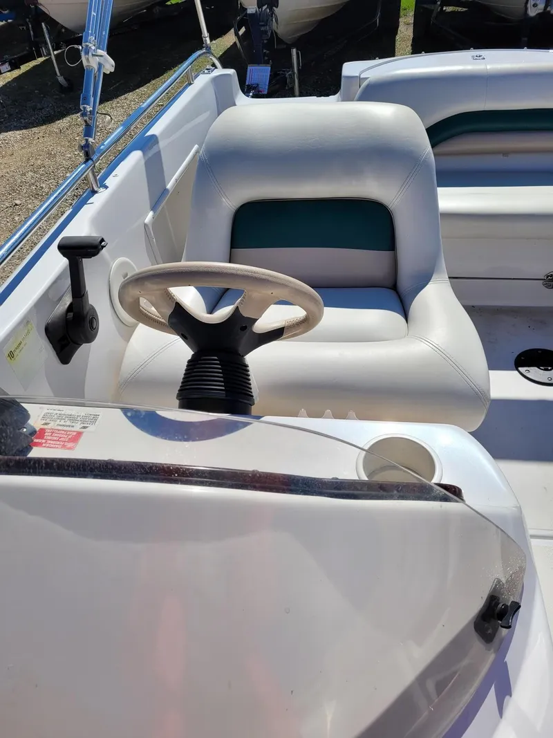 Slide: The Image of 2000 Hurricane Fun Deck 201IO boat interior with steering wheel and seating. - 17
