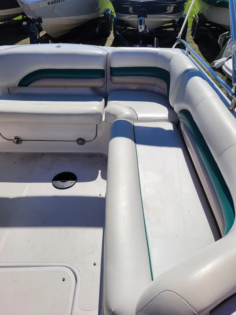 Slide: The Image of Interior seating of a 2000 Hurricane Fun Deck 201IO boat with white and green upholstery. - 19