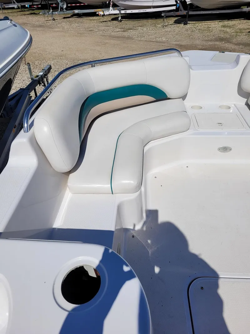 Slide: The Image of 2000 Hurricane Fun Deck 201IO boat interior with white and teal seating. - 9