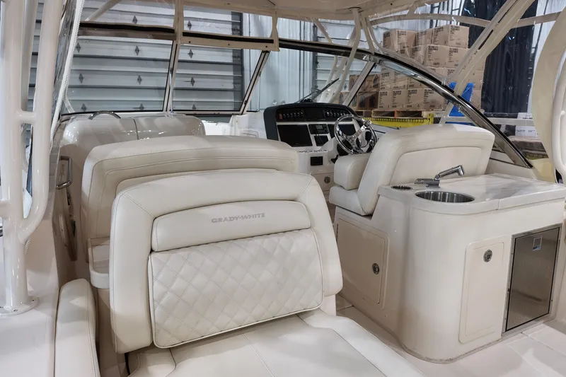 Slide: The Image of 2024 Grady-White Freedom 307 boat cockpit with steering wheel and control panel. - 10