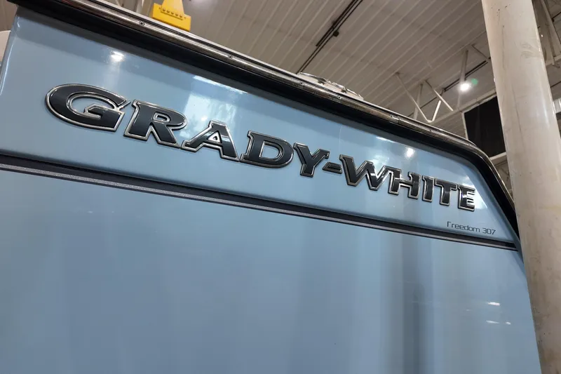 Slide: The Image of 2024 Grady-White Freedom 307 boat dashboard with advanced navigation and control systems. - 11
