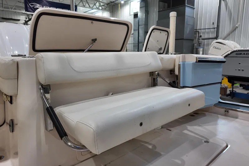 Slide: The Image of 2024 Grady-White Freedom 307 boat interior with bathroom and wooden accents. - 17