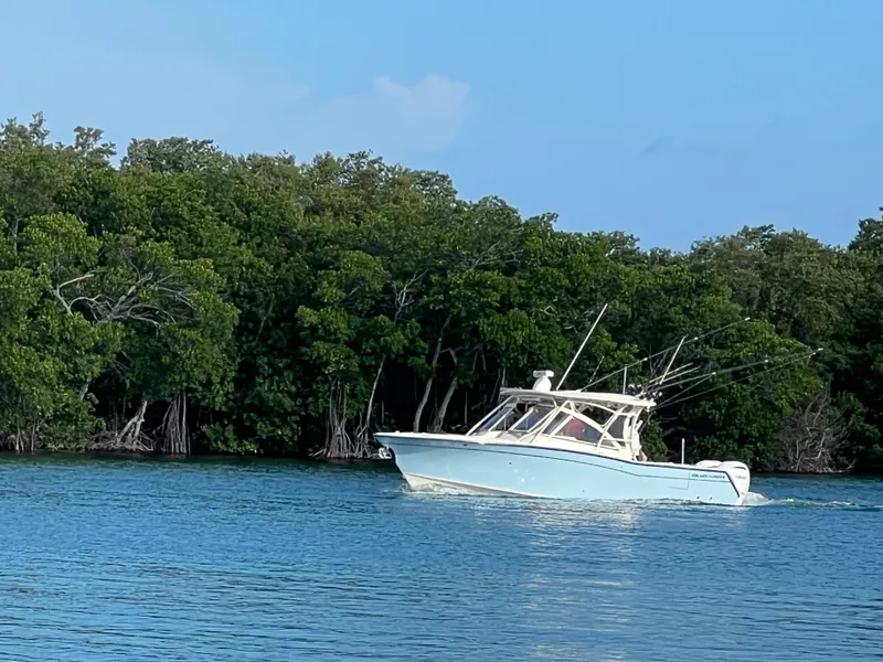 Slide: The Image of Storage compartment on 2024 Grady-White Freedom 307 boat with yellow extension cord. - 18