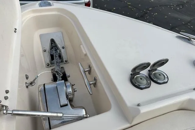 Slide: The Image of 2024 Grady-White Freedom 307 boat anchor compartment with winch and cleats. - 23