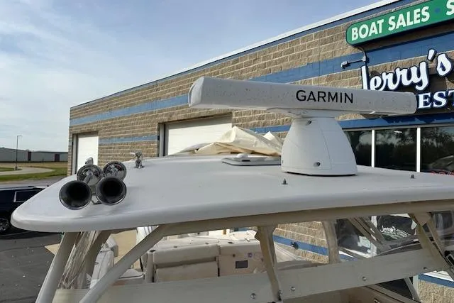 Slide: The Image of 2024 Grady-White Freedom 307 boat with Garmin radar, displayed at a boat sales location. - 25