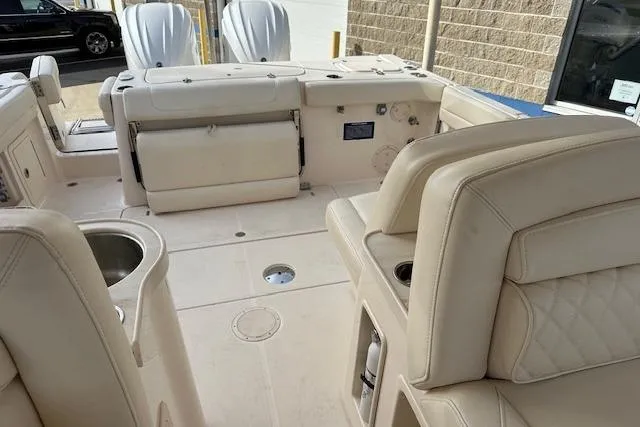 Slide: The Image of 2024 Grady-White Freedom 307 boat interior with beige seating and modern amenities. - 26