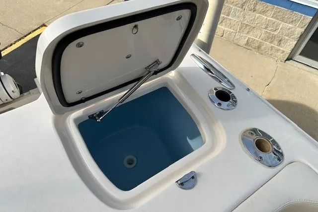 Slide: The Image of 2024 Grady-White Freedom 307 boat with open storage compartment and fishing rod holders. - 29