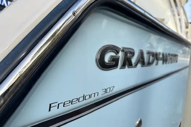 Slide: The Image of 2024 Grady-White Freedom 307 boat, close-up of model name on hull. - 31