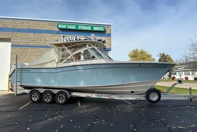 Slide: The Image of 2024 Grady-White Freedom 307 boat on trailer outside sales and service building. - 32