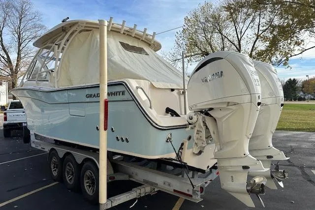 Slide: The Image of 2024 Grady-White Freedom 307 boat on trailer with twin Yamaha outboard engines. - 35