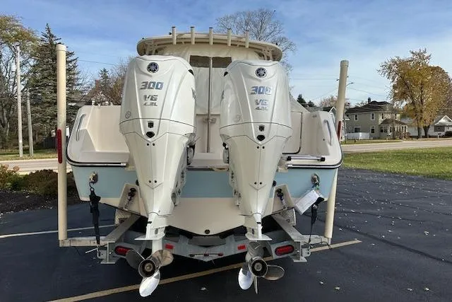 Slide: The Image of 2024 Grady-White Freedom 307 boat with twin 300 V6 engines, parked outdoors. - 37