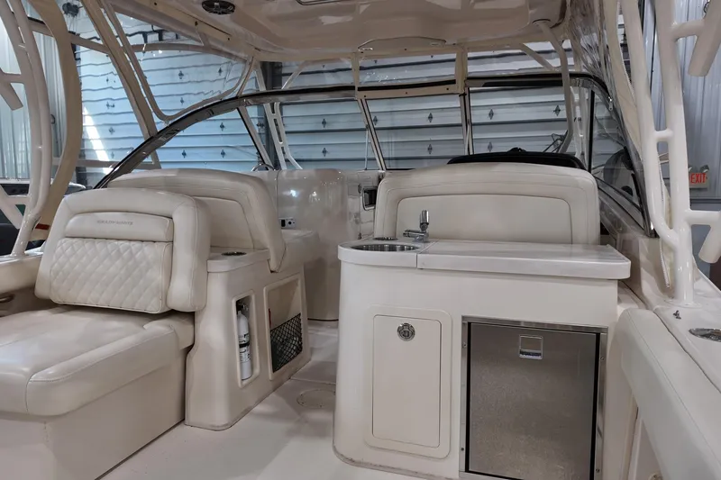 Slide: The Image of 2024 Grady-White Freedom 307 boat interior with beige seating and cup holder. - 9