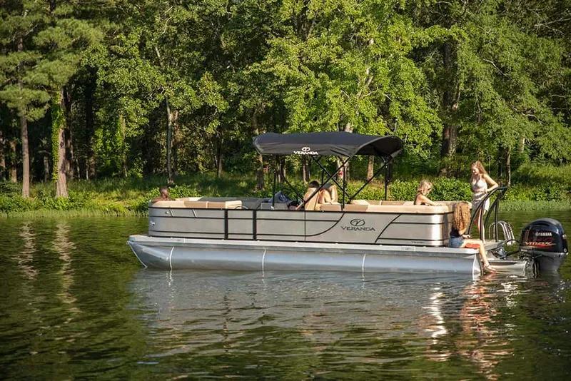 Slide: The Image of 2022 Veranda VR25RC pontoon boat cruising on a lake with passengers. - 10