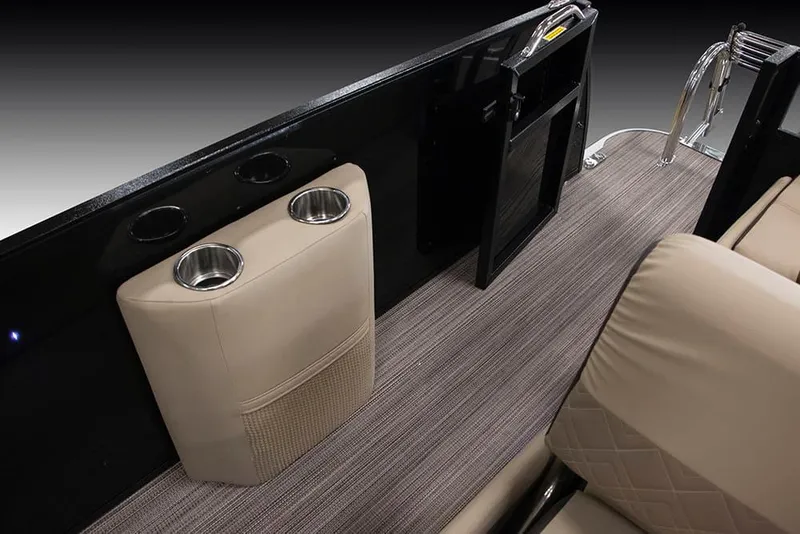 Slide: The Image of 2022 Veranda VP25VLC boat interior with cup holders and beige seating. - 25