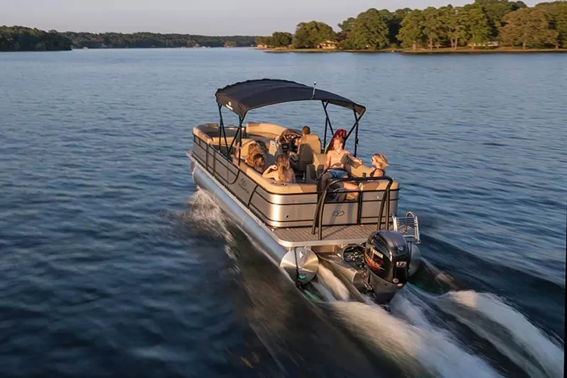 Slide: The Image of 2022 Veranda VR25RC pontoon boat cruising on a lake with passengers. - 13
