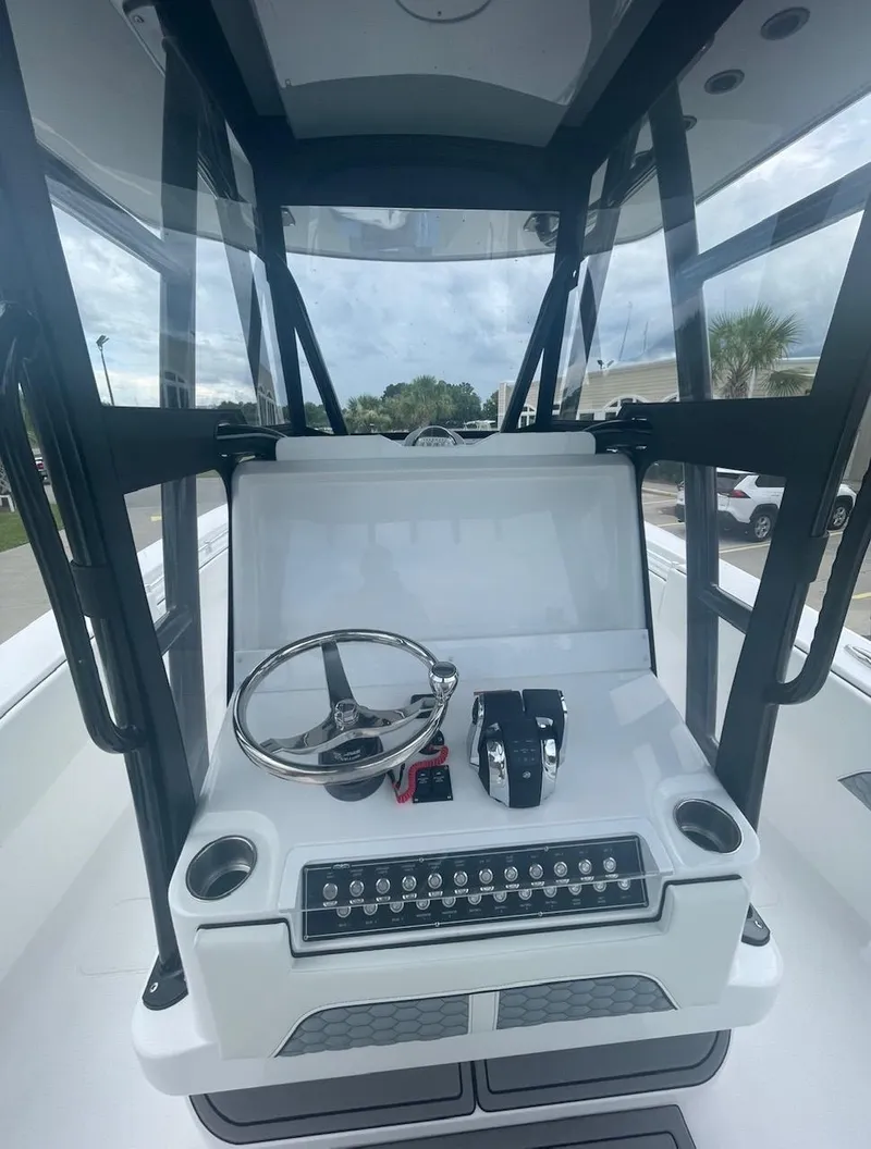 Slide: The Image of 2024 Invincible 33 Open Fisherman boat console with steering wheel and controls. - 8