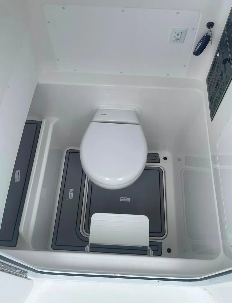 Slide: The Image of 2024 Invincible 33 Open Fisherman boat interior toilet. - 6