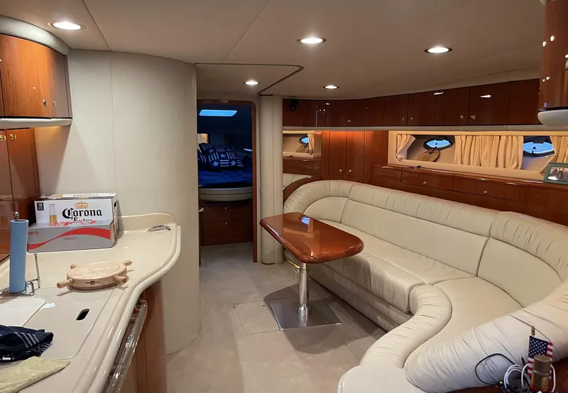 Slide: The Image of Luxurious interior of a 2000 Sea Ray 540 Sundancer yacht with plush seating and wooden accents. - 11