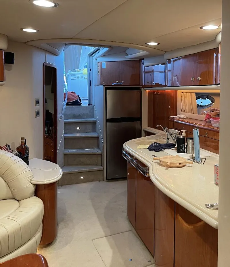 Slide: The Image of Interior of 2000 Sea Ray 540 Sundancer yacht with modern kitchen and seating area. - 14