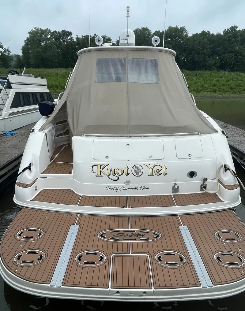Slide: The Image of 2000 Sea Ray 540 Sundancer yacht docked, featuring teak deck and covered cockpit. - 15
