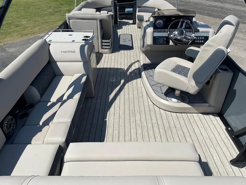 Slide: The Image of 2024 Harris 270 Grand Mariner boat interior with luxurious seating and modern helm. - 14