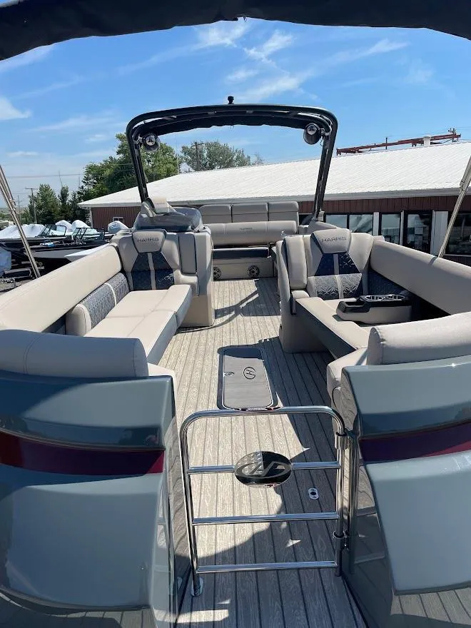 Slide: The Image of 2024 Harris 270 Grand Mariner pontoon boat with spacious seating and modern design. - 2