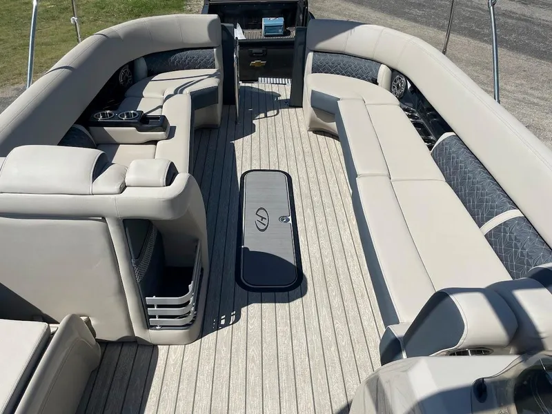 Slide: The Image of 2024 Harris 270 Grand Mariner pontoon boat with spacious seating and modern interior. - 4