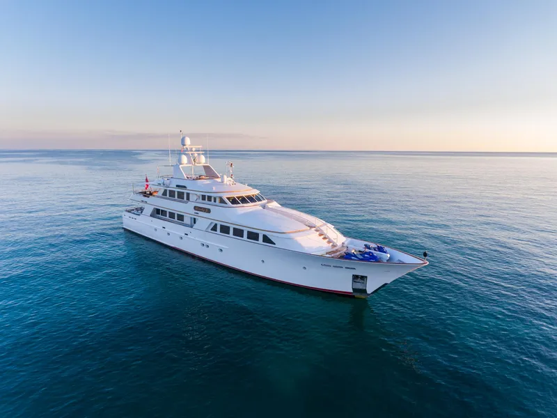 Slide: The Image of 1997 Palmer Johnson Motor Yacht cruising on calm blue waters at sunset. - 1