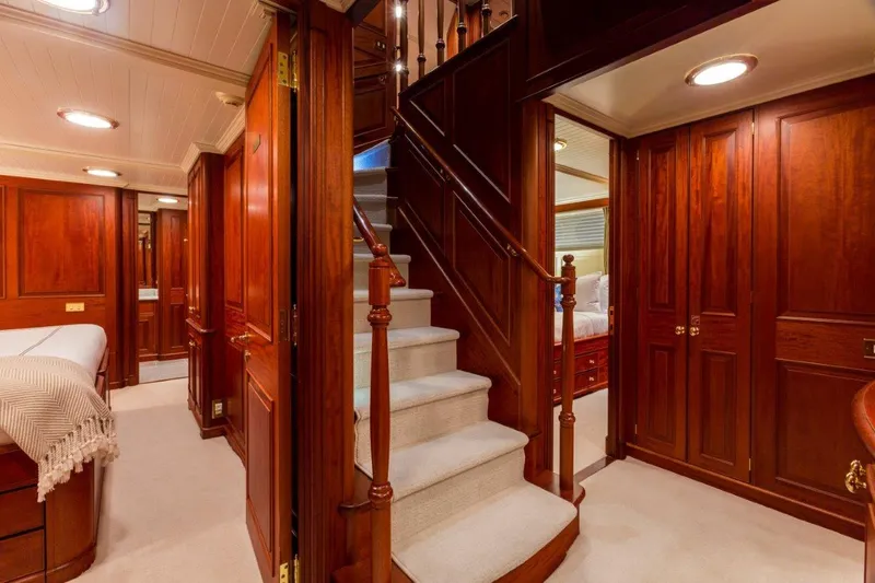 Slide: The Image of Luxurious 1997 Palmer Johnson motor yacht interior with elegant wood paneling and staircase. - 11