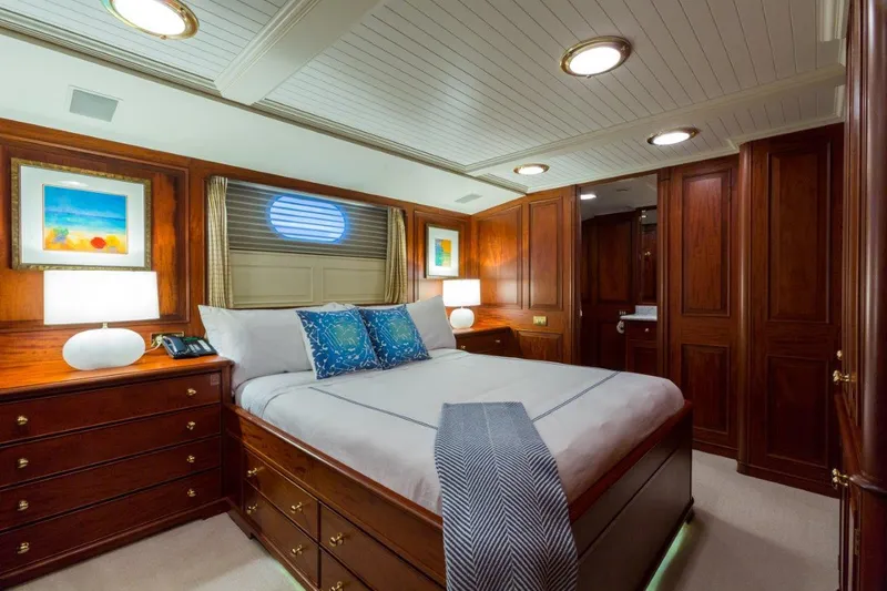 Slide: The Image of Luxurious 1997 Palmer Johnson motor yacht bedroom with elegant wood paneling and cozy decor. - 14