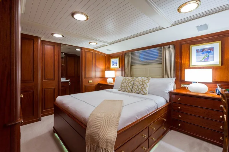 Slide: The Image of Luxurious 1997 Palmer Johnson motor yacht bedroom with elegant wood paneling and cozy lighting. - 15