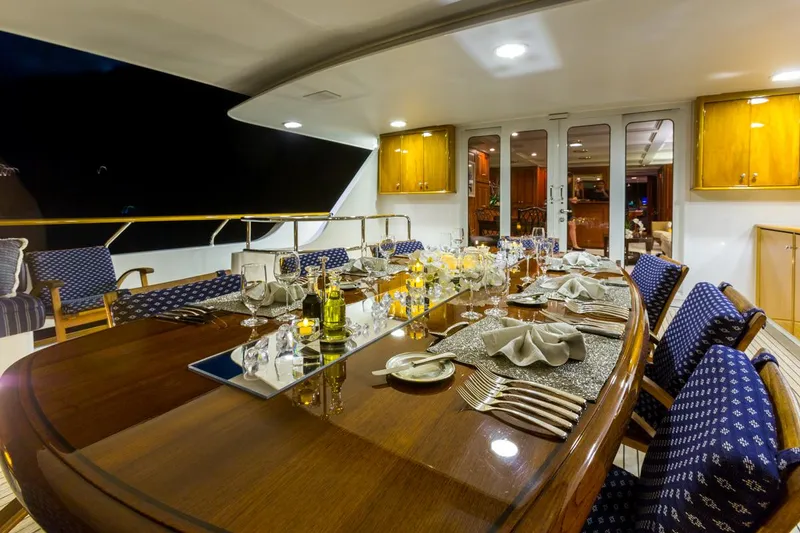 Slide: The Image of Luxurious dining setup on 1997 Palmer Johnson motor yacht, featuring elegant tableware and ambient lighting. - 19