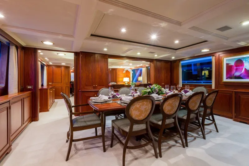 Slide: The Image of Luxurious dining area on 1997 Palmer Johnson motor yacht with elegant wood paneling. - 5
