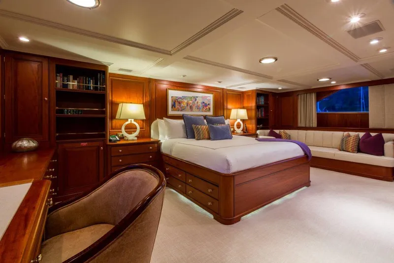 Slide: The Image of Luxurious 1997 Palmer Johnson motor yacht bedroom with elegant wood furnishings and ambient lighting. - 8