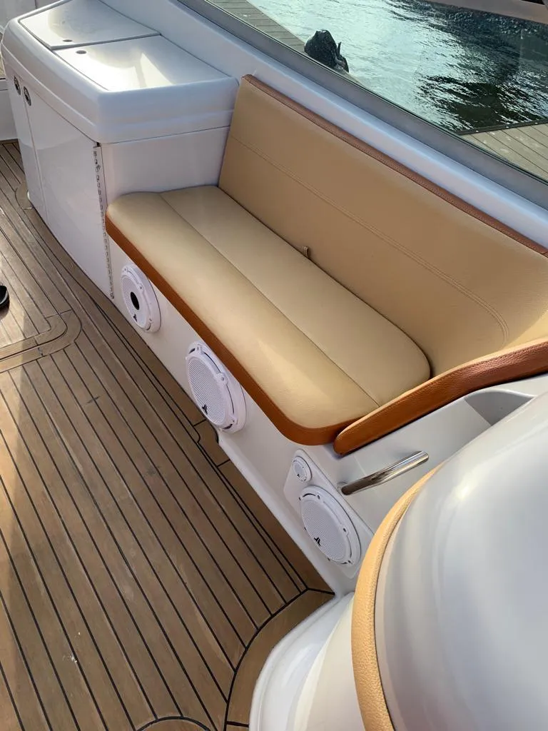 Slide: The Image of 1999 Formula 280 Bowrider boat with tan seating and wooden deck. - 10