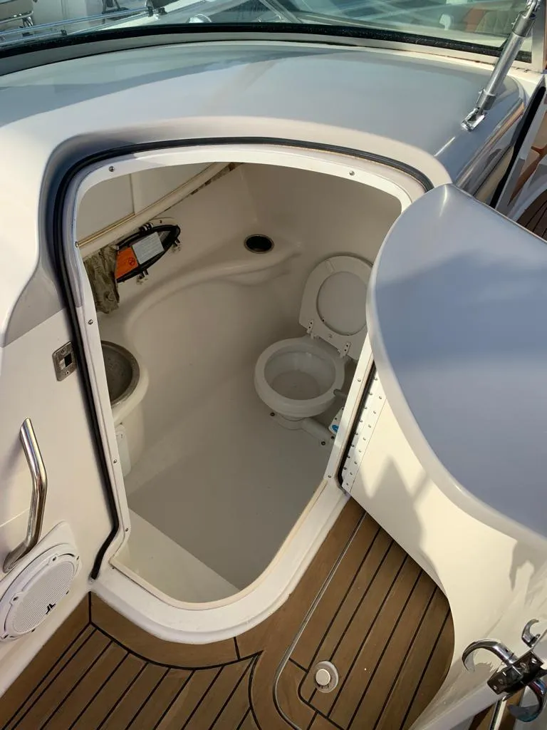 Slide: The Image of 1999 Formula 280 Bowrider boat interior with open bathroom compartment. - 11