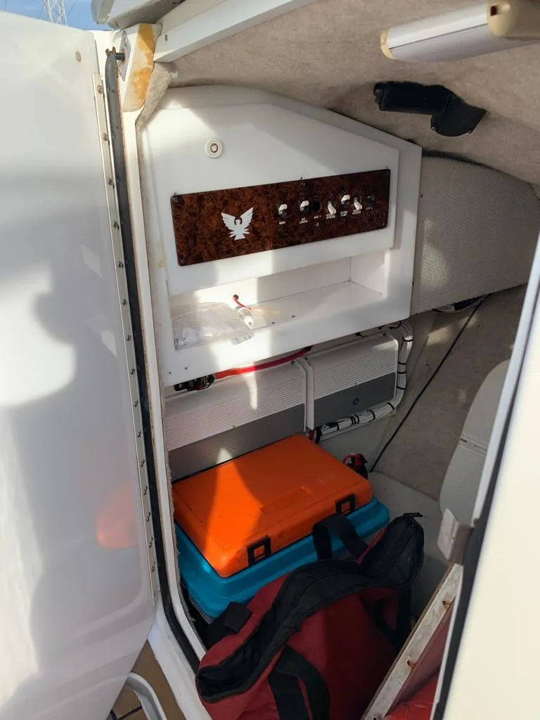 Slide: The Image of 1999 Formula 280 Bowrider cabin storage area with equipment and bags. - 12