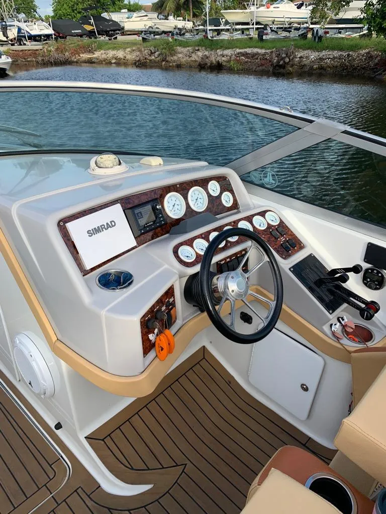 Slide: The Image of 1999 Formula 280 Bowrider boat dashboard with steering wheel and navigation instruments. - 2