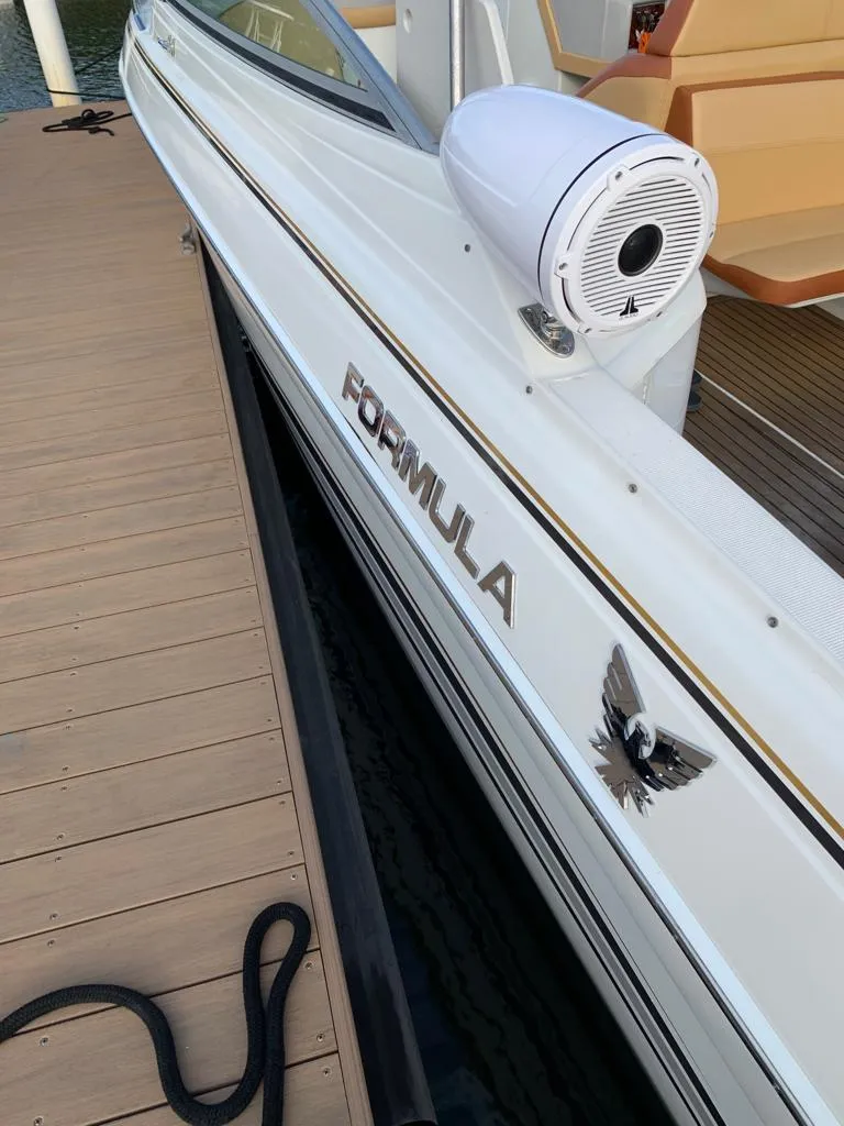 Slide: The Image of 1999 Formula 280 Bowrider docked, showcasing sleek design and branding. - 22