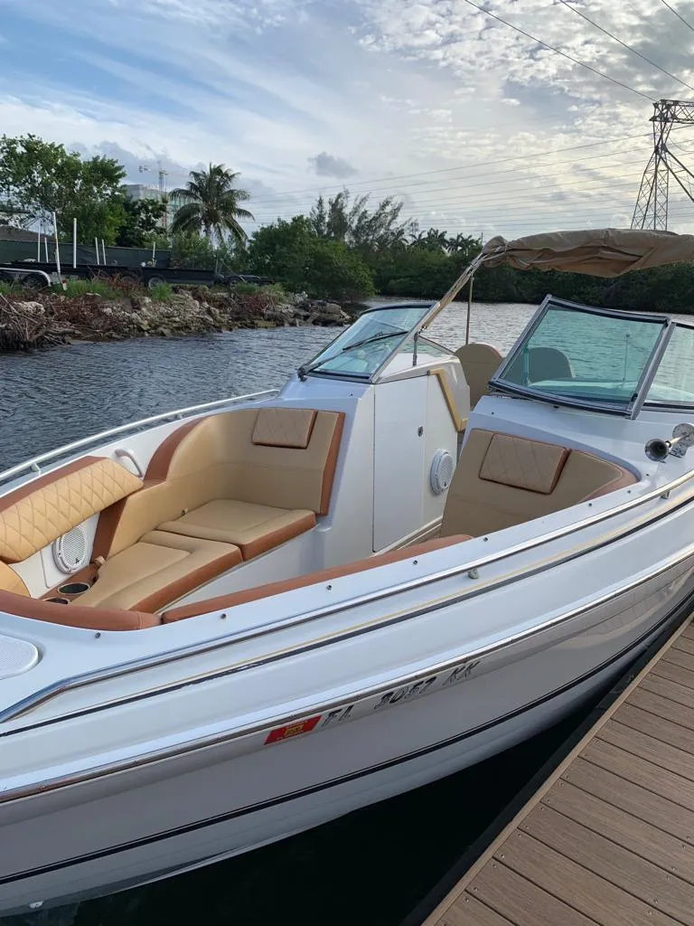 Slide: The Image of 1999 Formula 280 Bowrider boat docked by a scenic waterway. - 23