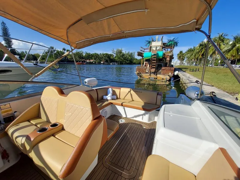 Slide: The Image of 1999 Formula 280 Bowrider boat with tan interior docked by a scenic waterfront. - 24