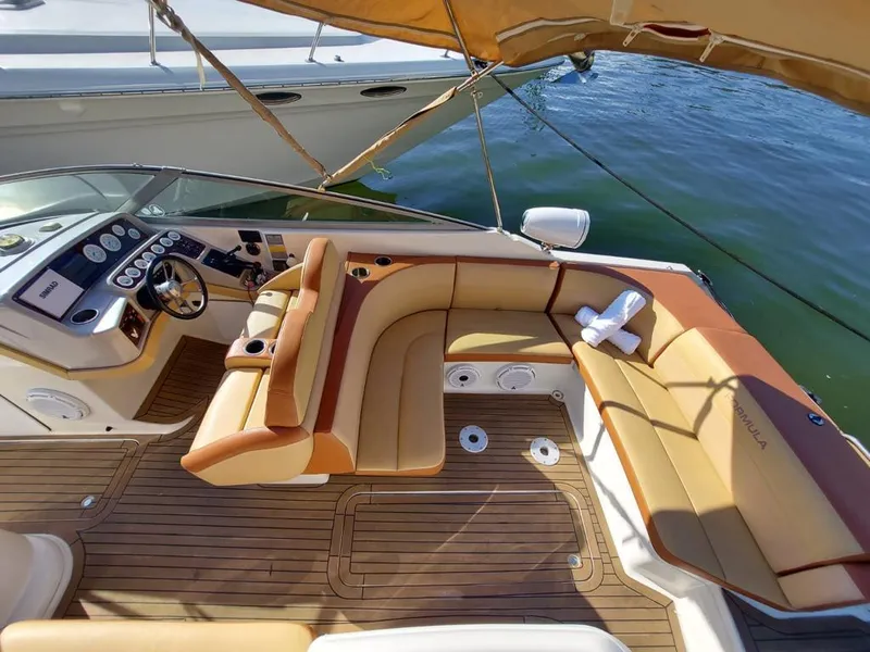Slide: The Image of 1999 Formula 280 Bowrider boat interior with tan leather seating and wooden flooring. - 26